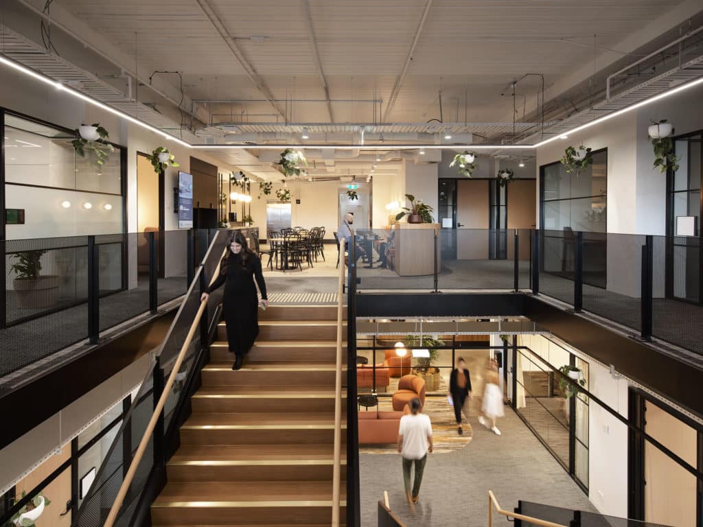 woman walking down stairs towards lounge area