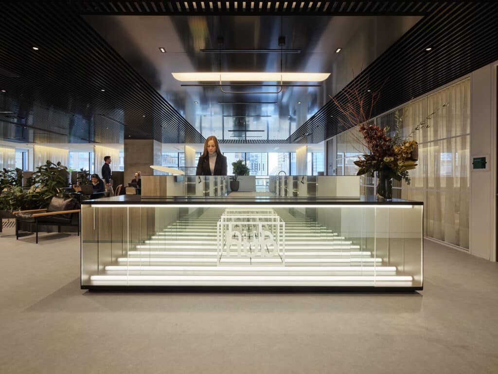 woman at concierge desk with Hub Australia logo