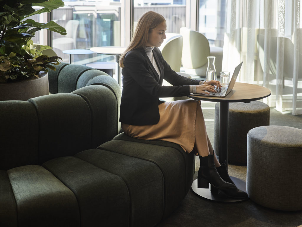 woman working in a cafe area in an office space