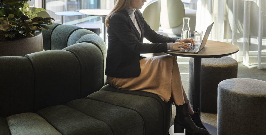 woman working in a cafe area in an office space