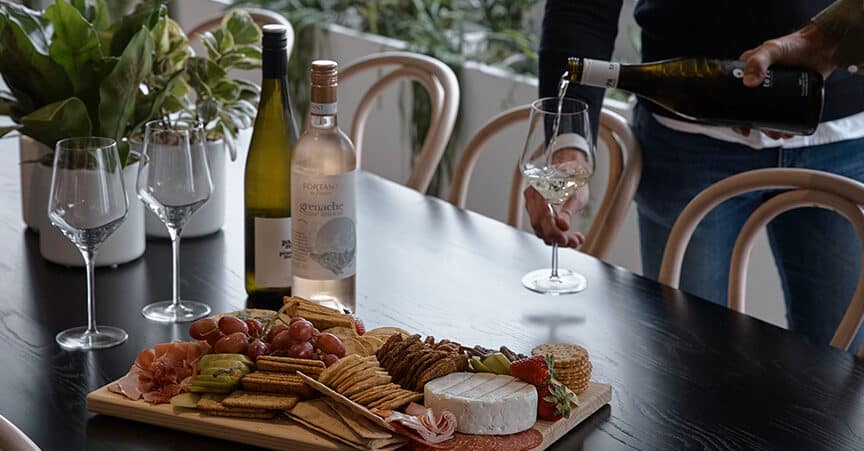 Wine down member event with cheese board and wine