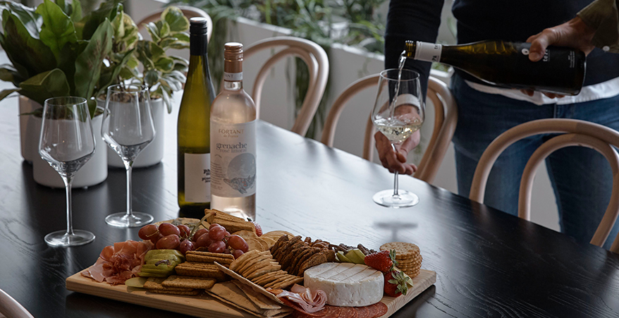 Wine down member event with cheese board and wine