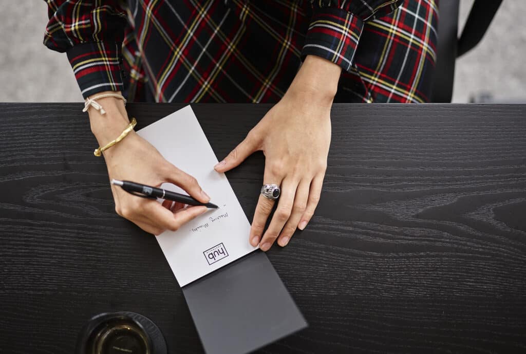 woman writing in notepad
