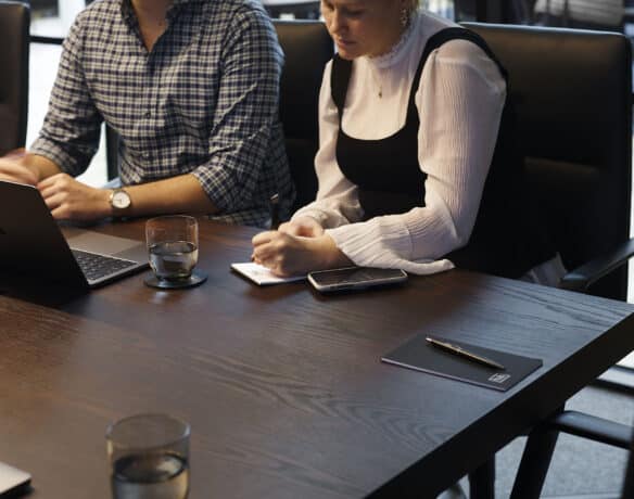 people in meeting writing notes