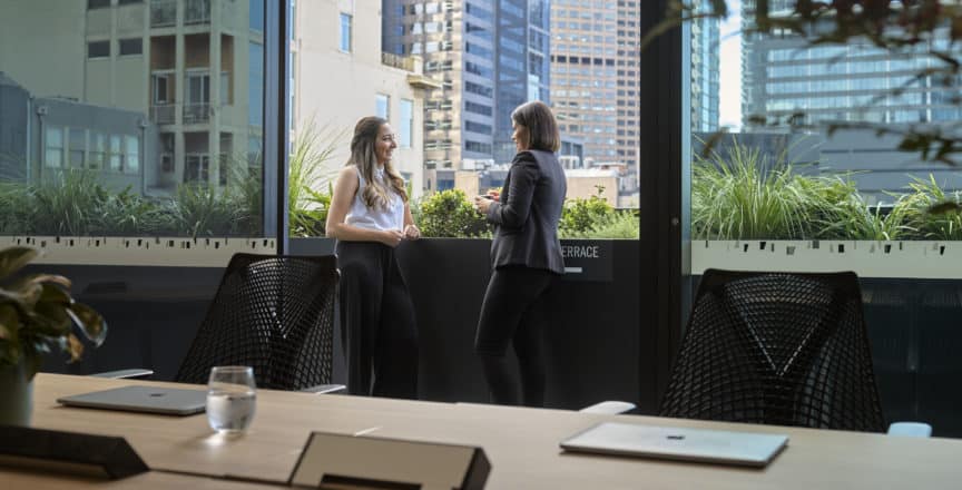 Two women standing on a terrace