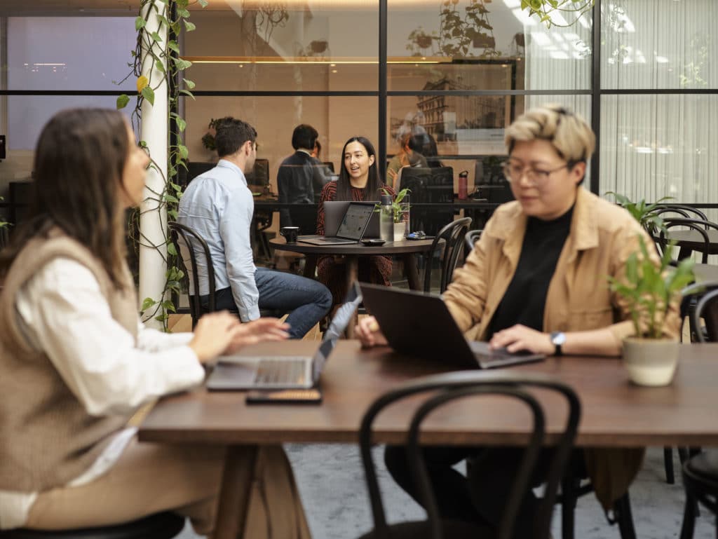 two women work in a cafe