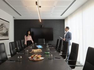 people discussing something over a meeting table