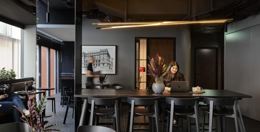 a woman sitting at her laptop in a café