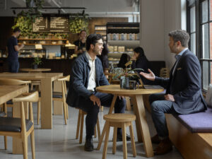 two men speaking in a cafe