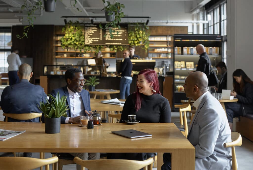 women and man having a meeting in a cafe