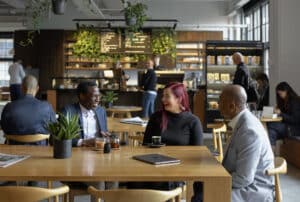 women and man having a meeting in a cafe