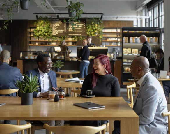 women and man having a meeting in a cafe