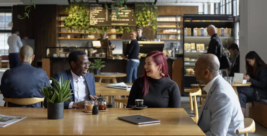 women and man having a meeting in a cafe