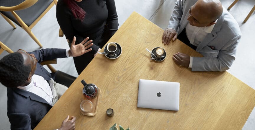 group of people having a meeting in a cafe