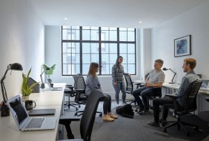 workers talking in an office setting