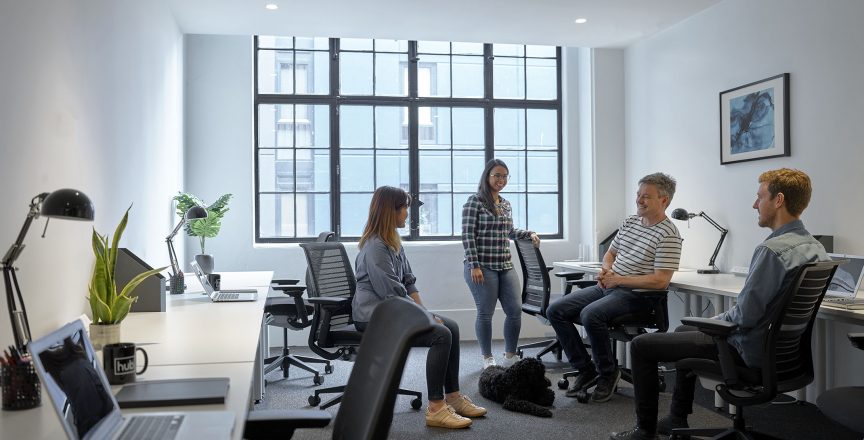 workers talking in an office setting