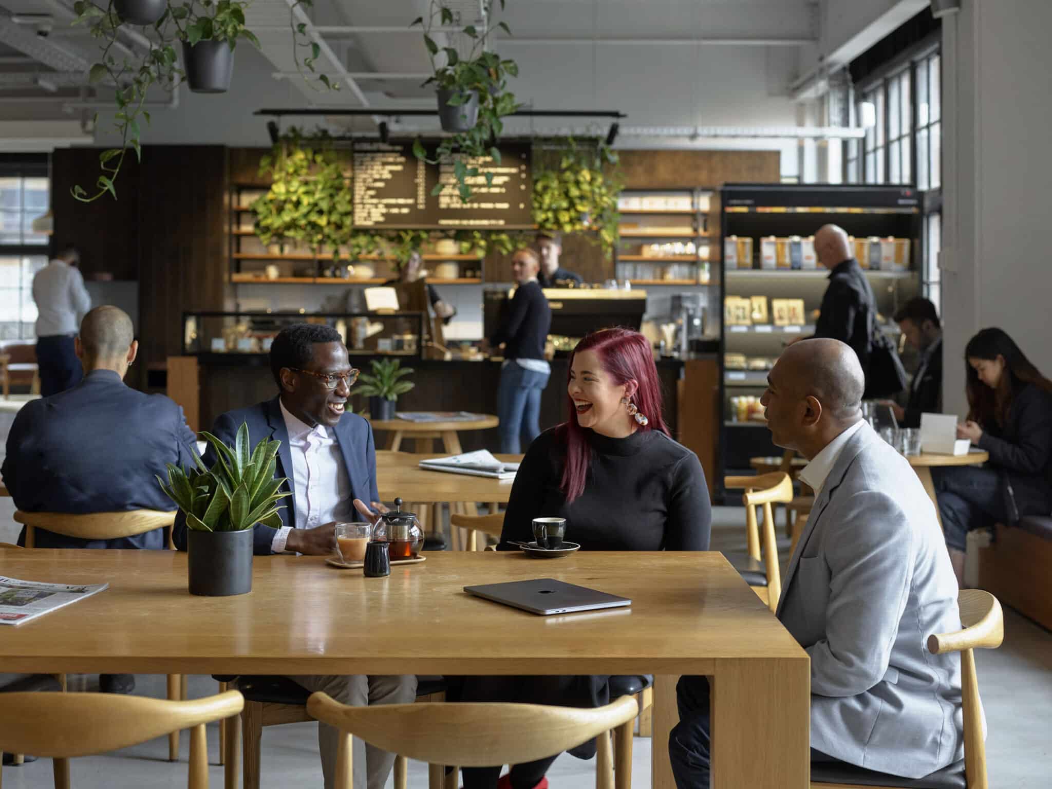 people sitting at a table in coworking cafe space