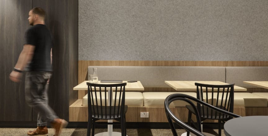 man walking through cafe space