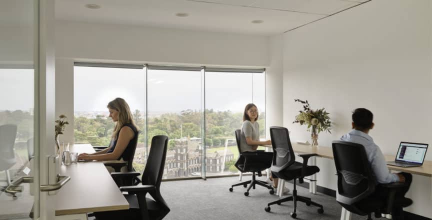people working in office with a view