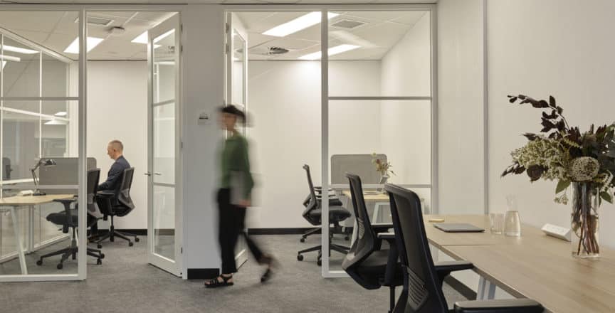 woman walking past an office