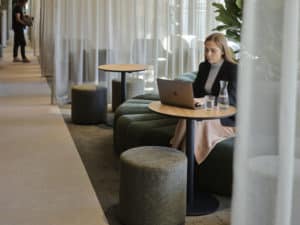 woman working on a laptop in a business lounge