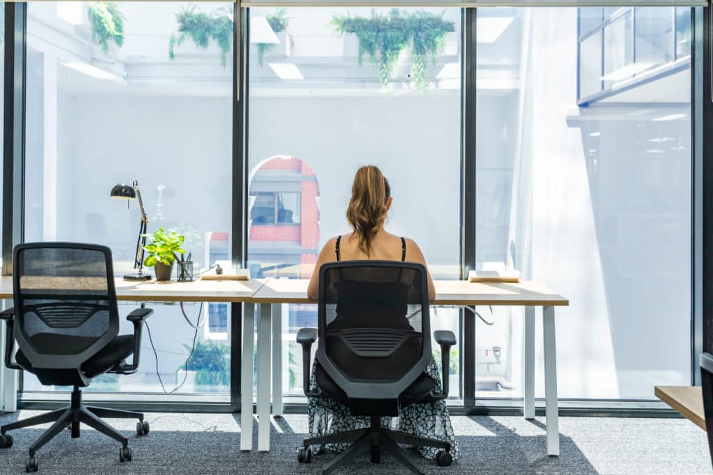 Woman working on her desk at Hub Adelaide