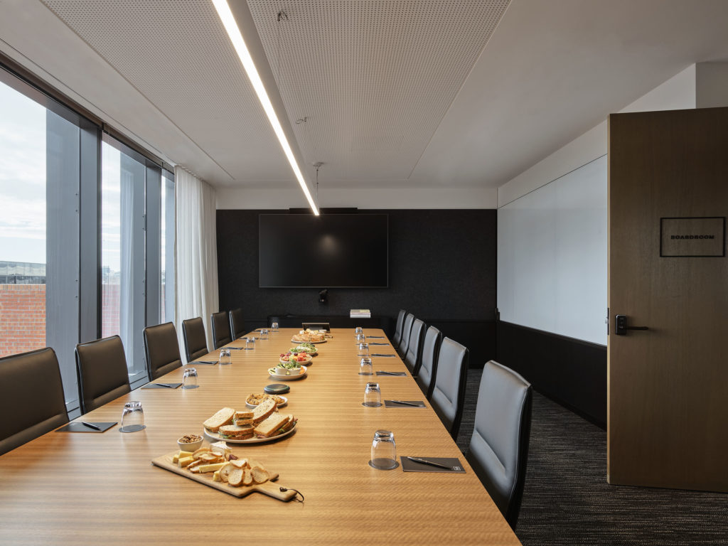 Boardroom table with food and chairs