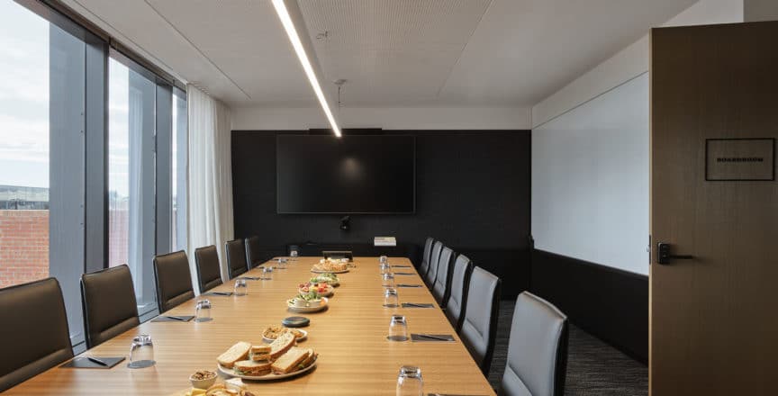Boardroom table with food and chairs