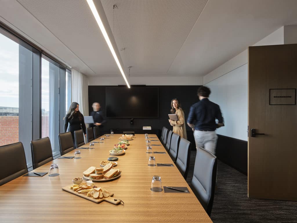 people in a boardroom with catering