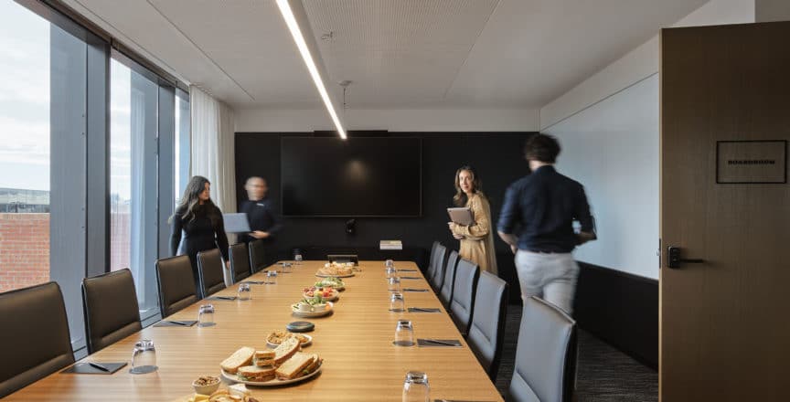 people in a boardroom with catering