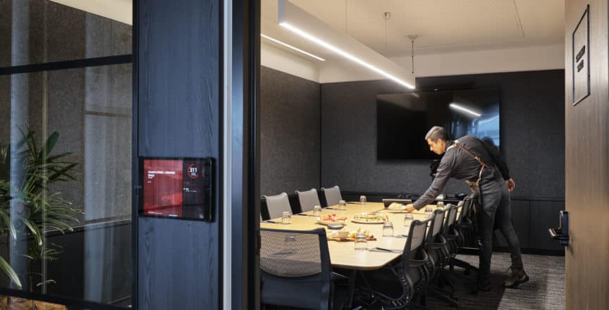 meeting room with catering on table and a waiter