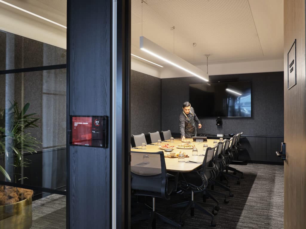 meeting room with catering on table and a waiter