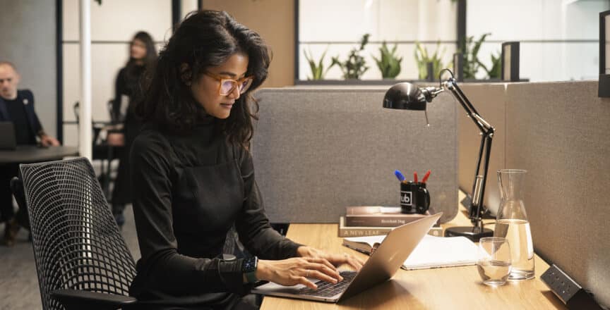woman typing on a laptop in an office