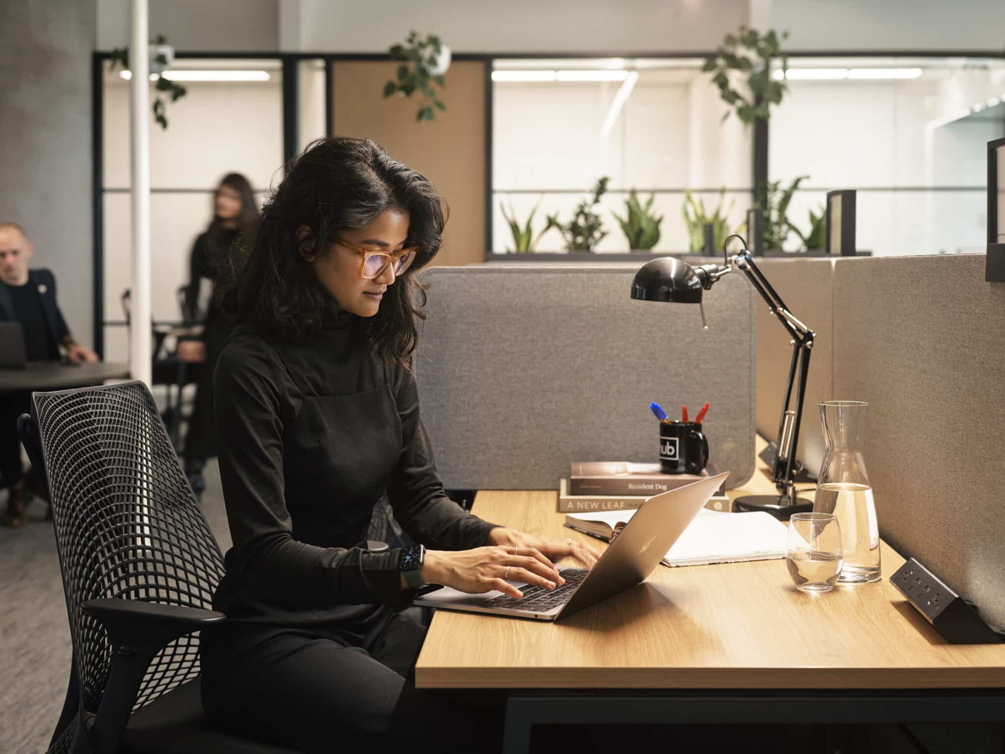 woman typing on a laptop in an office