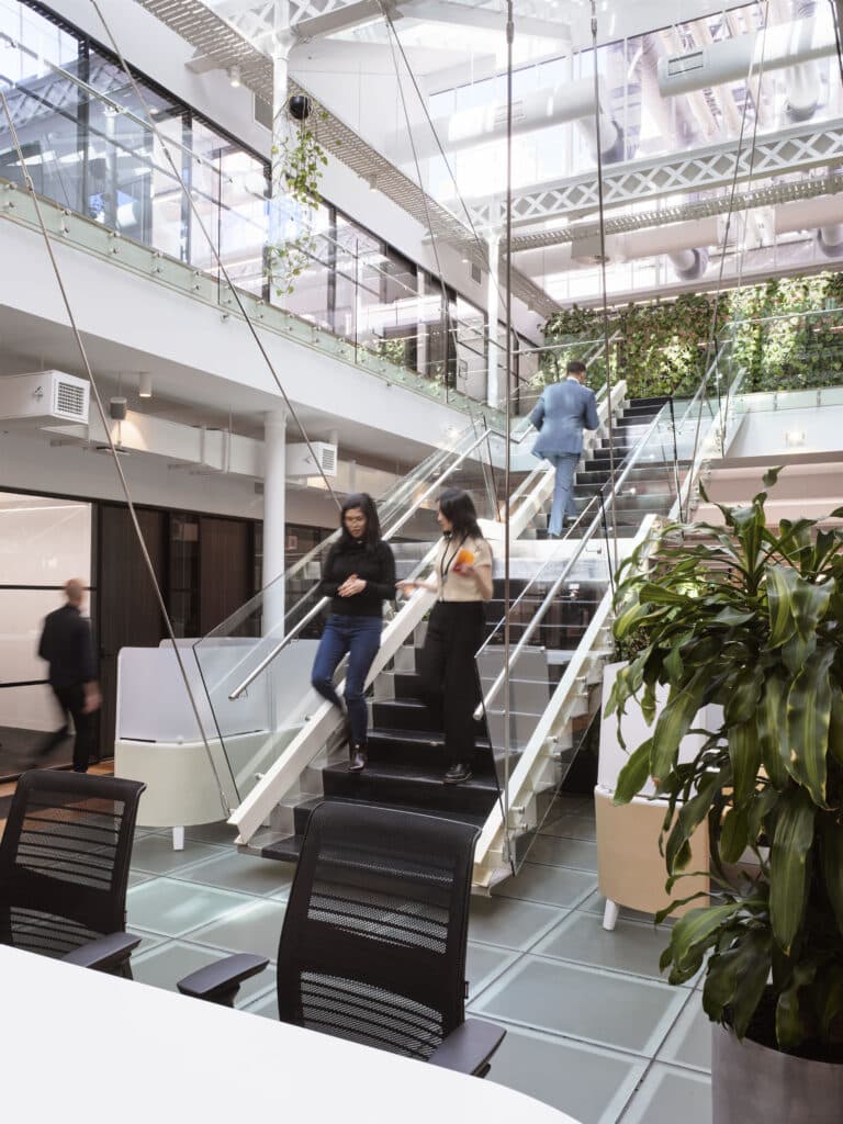 two people walking down the stairs in a shared workspace