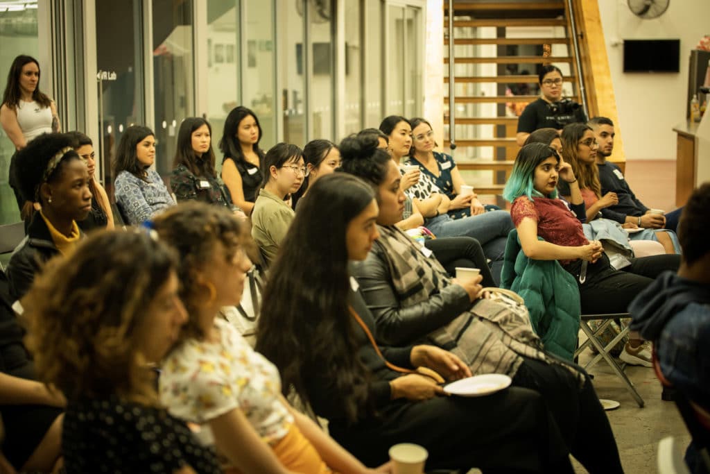 group of people listening to a lecture 