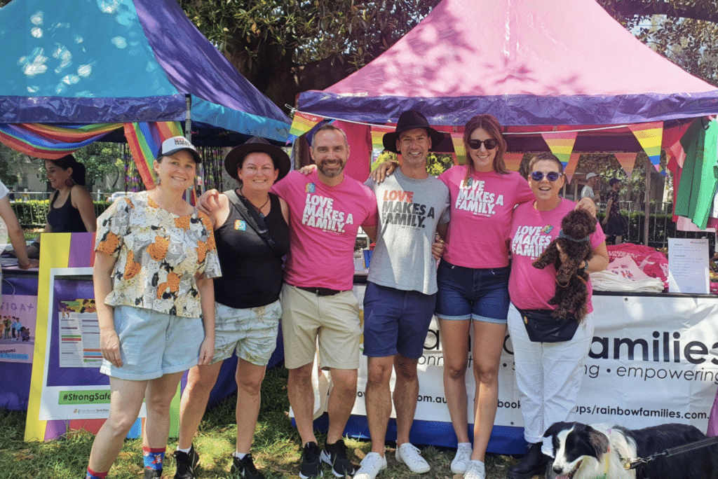 A group of people standing together with pink tshirts on