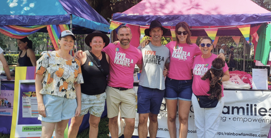 A group of people standing together with pink tshirts on