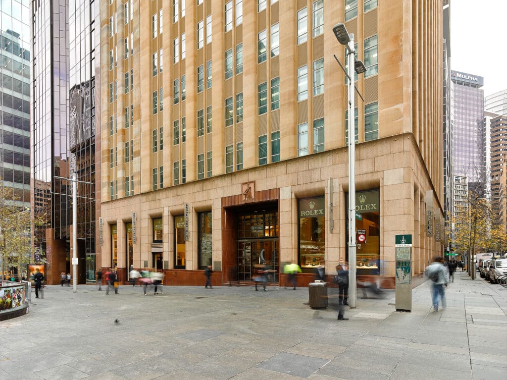 An external shot of a building, with people walking around