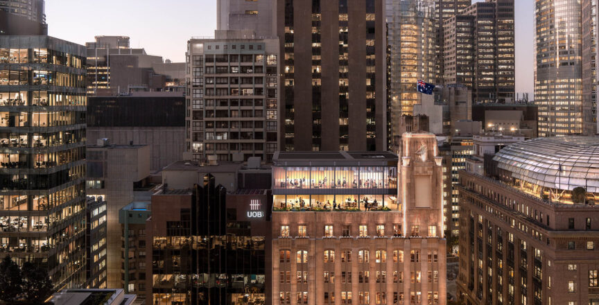 A night time shot of the exterior building of Hub Martin place, featuring lit up windows.