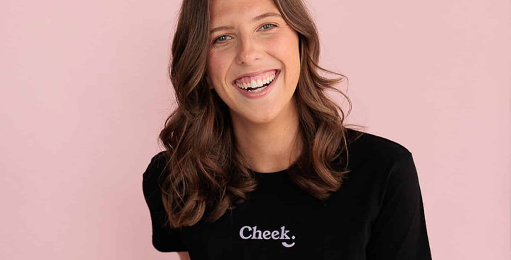 woman standing infront of a pink wall