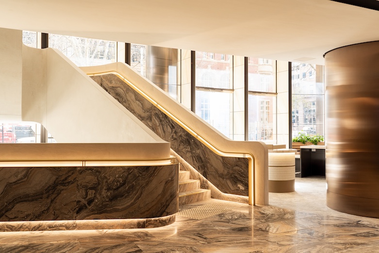 brightly lit marble staircase in a grand lobby