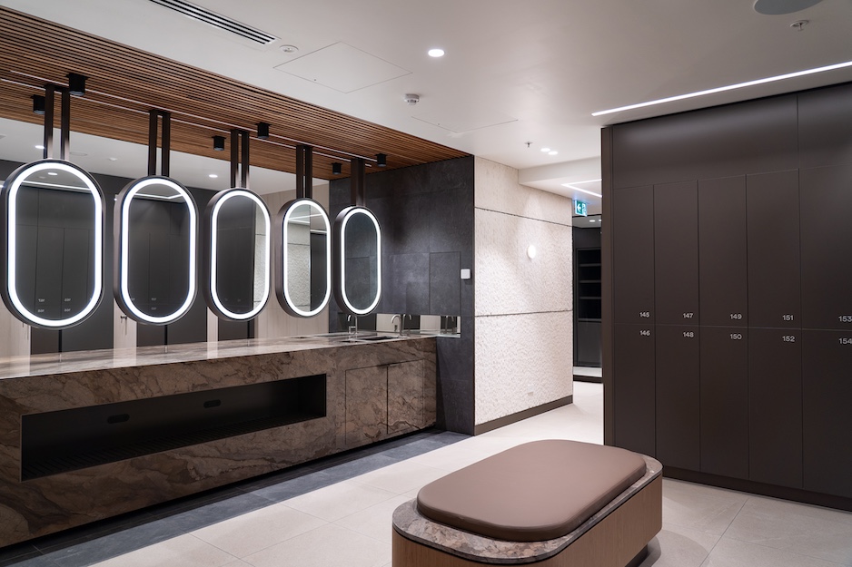 modern bathroom with marble fixtures, bench and lockers