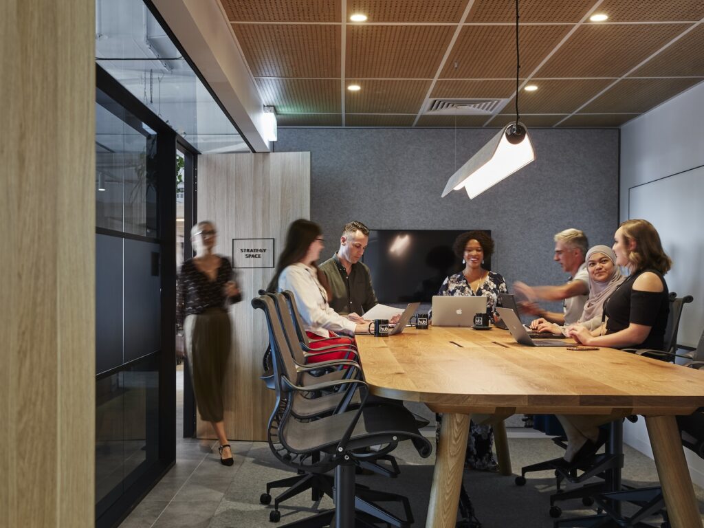 A group of coworkers discussing strategy in a meeting room.