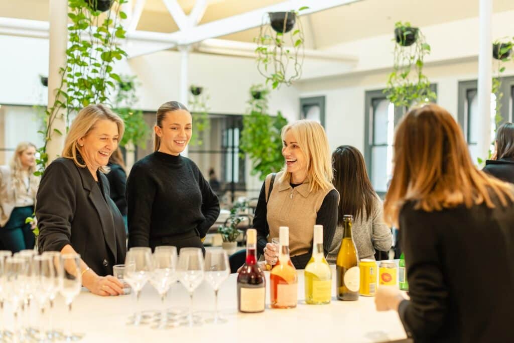 Women mingling during an event at Hub Australia
