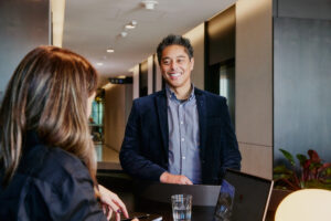 Man at welcome desk smiling at concierge