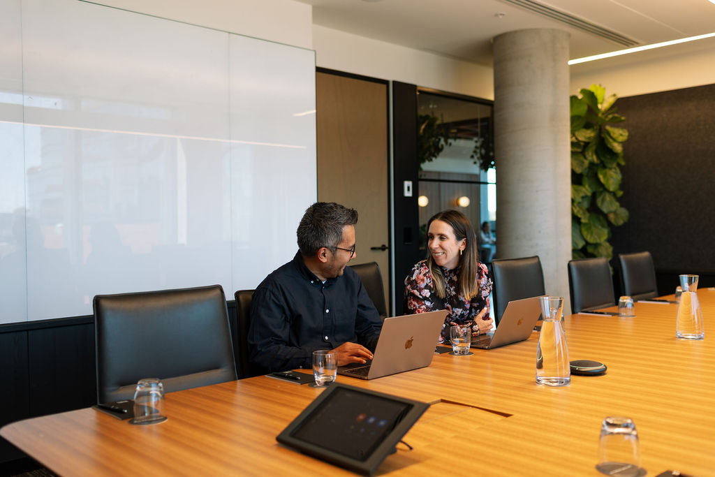 Professionals collaborating in a Hub Australia executive boardroom to improve employee engagement.